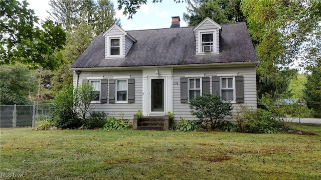 cape cod home featuring a front lawn