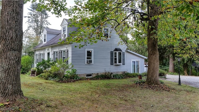 view of side of home featuring a yard