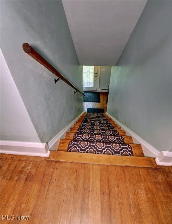 stairway featuring hardwood / wood-style flooring