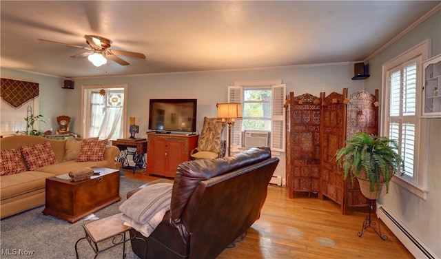 living room featuring a baseboard radiator, light hardwood / wood-style flooring, a wealth of natural light, and ceiling fan