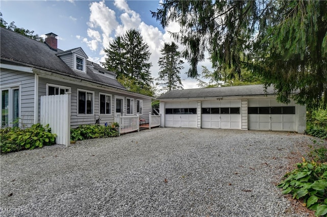 view of front of home with an outdoor structure and a garage