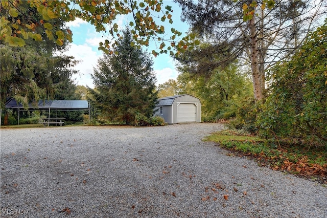 exterior space featuring an outbuilding, a garage, and a carport