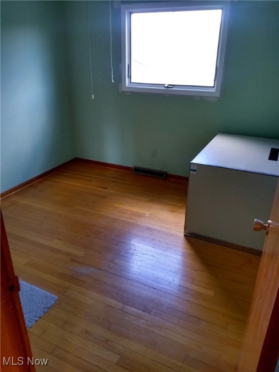 unfurnished room featuring light hardwood / wood-style floors