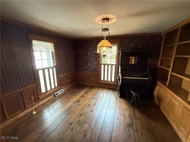 unfurnished dining area with dark wood-type flooring