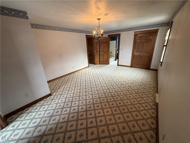 unfurnished room with a chandelier