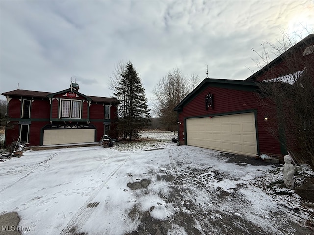 view of snowy exterior with a garage