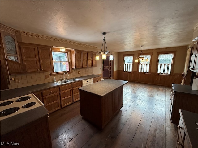 kitchen featuring a kitchen island, dark hardwood / wood-style flooring, hanging light fixtures, and a wealth of natural light