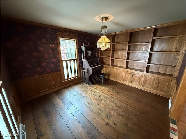 interior space with dark wood-type flooring and an inviting chandelier