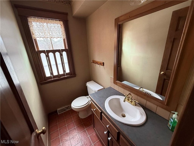 7917 Columbiana Canfield Rd, Canfield, OH 44406 - bathroom with toilet, vanity, baseboards, and tile patterned flooring