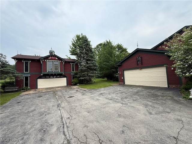 7917 Columbiana Canfield Rd, Canfield, OH 44406 - view of front of property featuring asphalt driveway and a garage