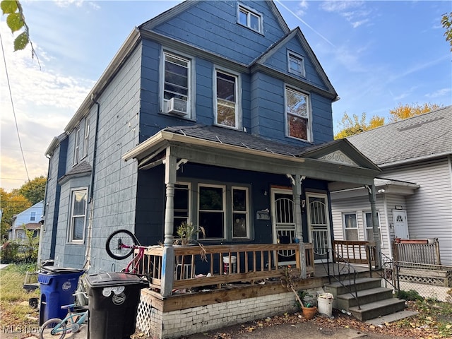 view of front facade featuring covered porch and cooling unit