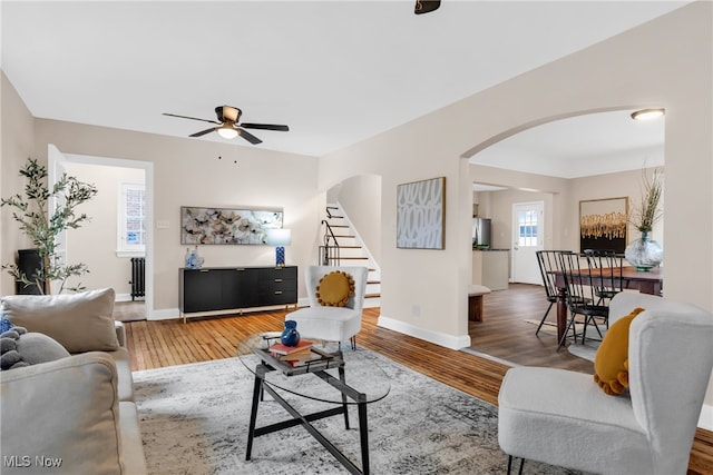 living room featuring ceiling fan, radiator heating unit, and wood-type flooring