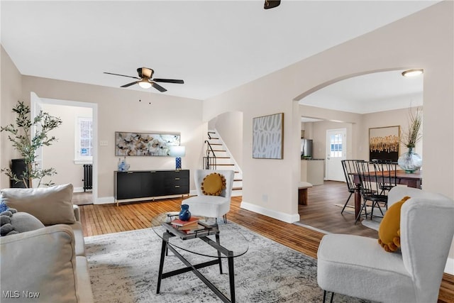 3781 Washington Blvd, University Heights, OH 44118 - living area featuring arched walkways, a ceiling fan, wood finished floors, and baseboards