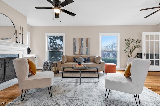 living room featuring light hardwood / wood-style flooring and ceiling fan