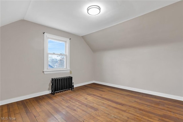 3781 Washington Blvd, University Heights, OH 44118 - additional living space with radiator heating unit, vaulted ceiling, hardwood / wood-style floors, and baseboards