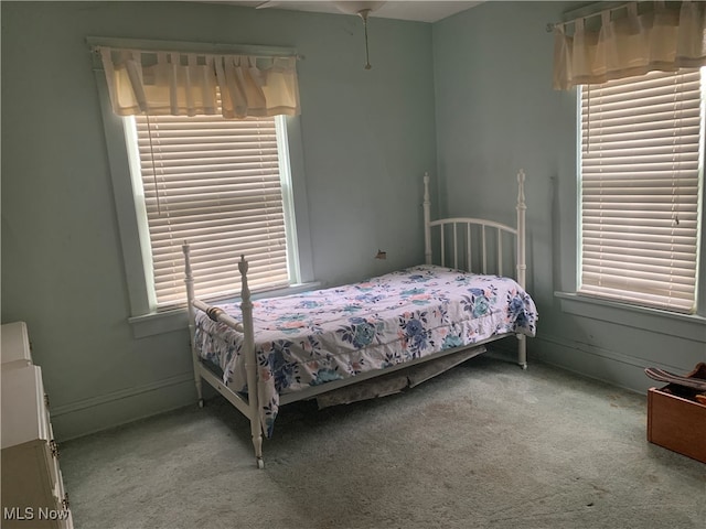 bedroom with ceiling fan and light colored carpet