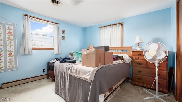 carpeted bedroom featuring a baseboard radiator