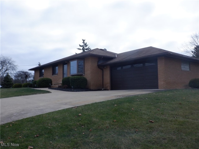 view of front of home with a front lawn and a garage