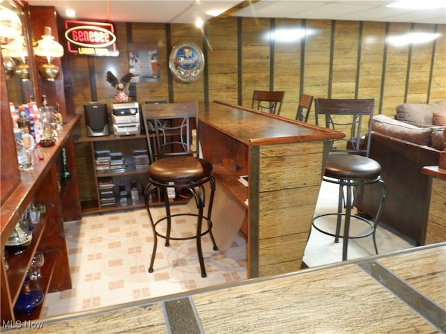 bar featuring wood walls