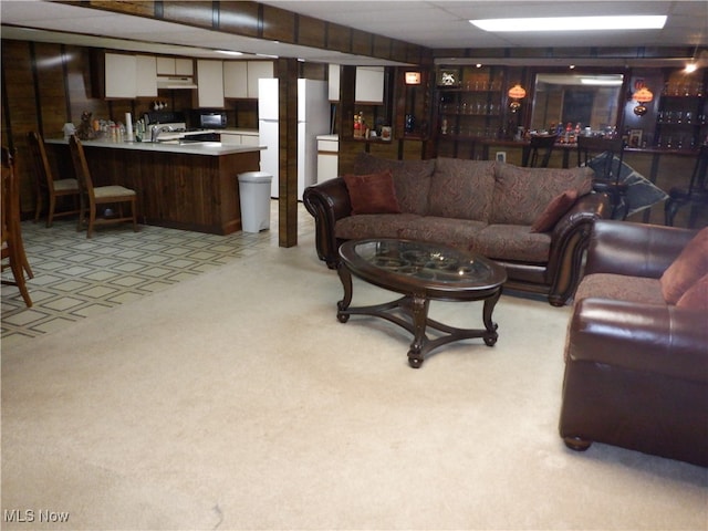 carpeted living room featuring wet bar