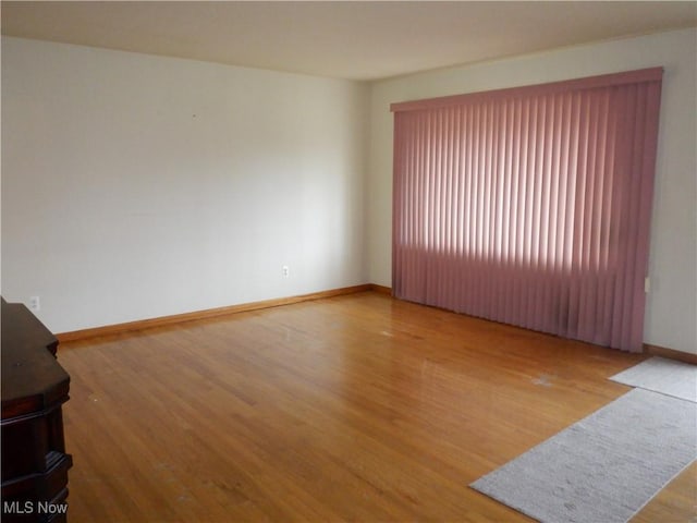 unfurnished room with light hardwood / wood-style floors