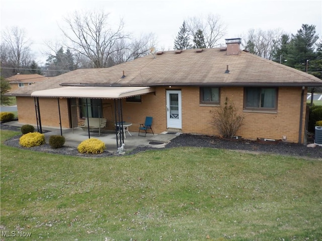 back of property featuring a lawn, a patio area, and central AC unit