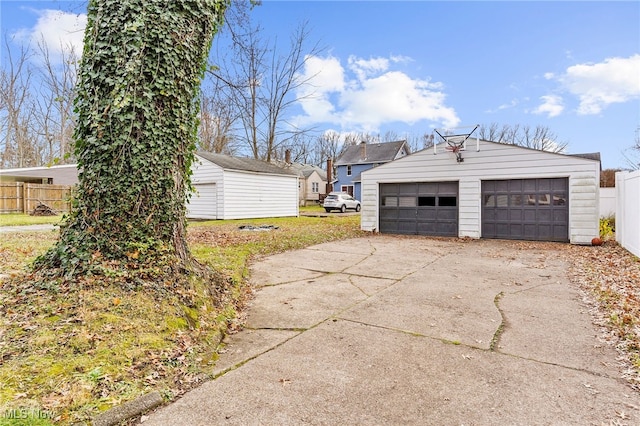 view of side of home with a garage and an outdoor structure