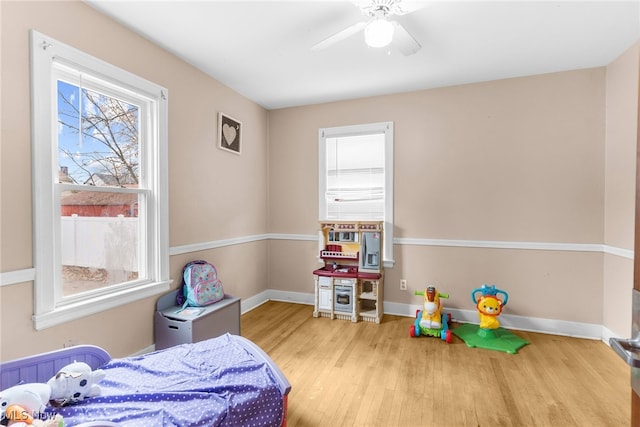 bedroom with ceiling fan and light wood-type flooring