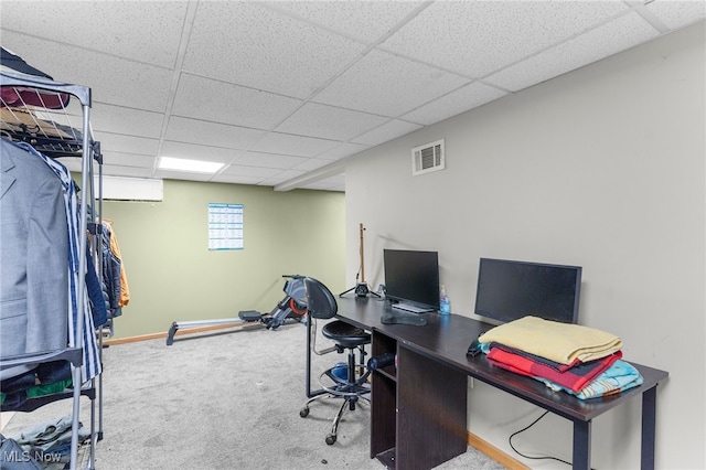 carpeted office featuring a paneled ceiling