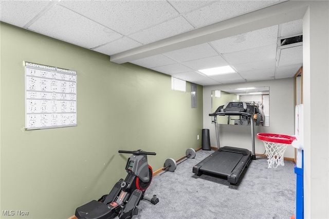 exercise room featuring carpet and a paneled ceiling