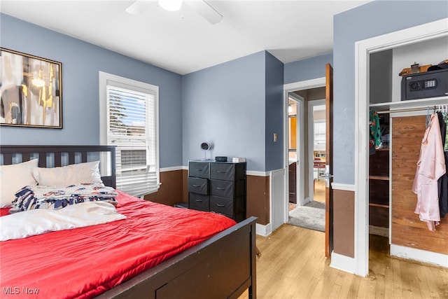 bedroom featuring ceiling fan, a closet, and light hardwood / wood-style flooring