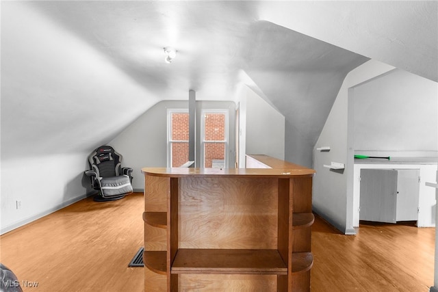 interior space with hardwood / wood-style floors and lofted ceiling