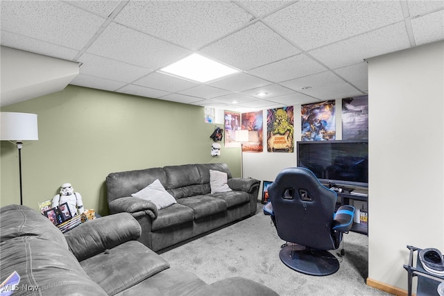 living room featuring carpet flooring and a paneled ceiling