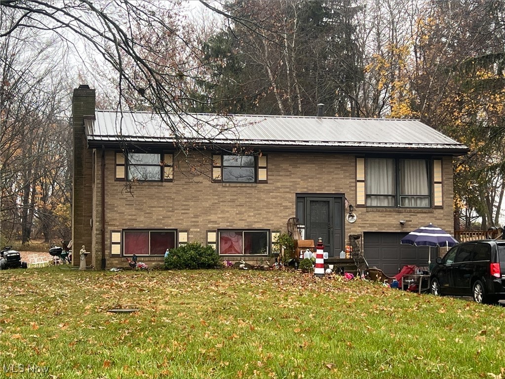 13270 Doylestown Rd, Rittman, OH 44270 - raised ranch with a chimney, a front yard, and metal roof