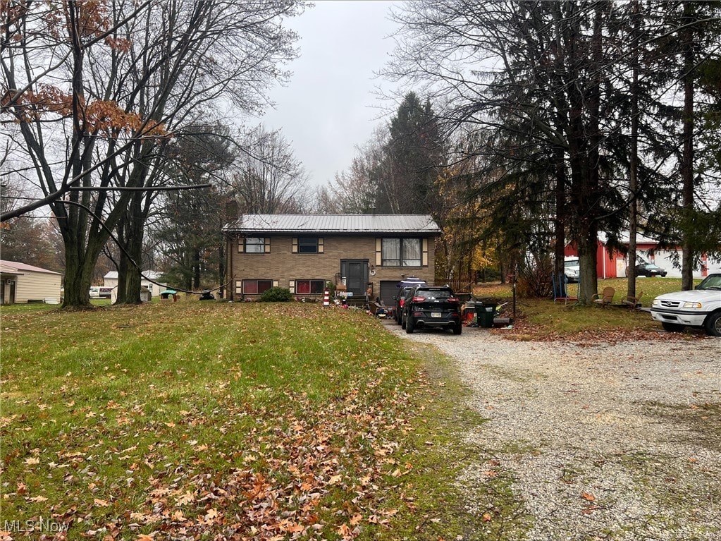 13270 Doylestown Rd, Rittman, OH 44270 - bi-level home with metal roof, driveway, and a front yard