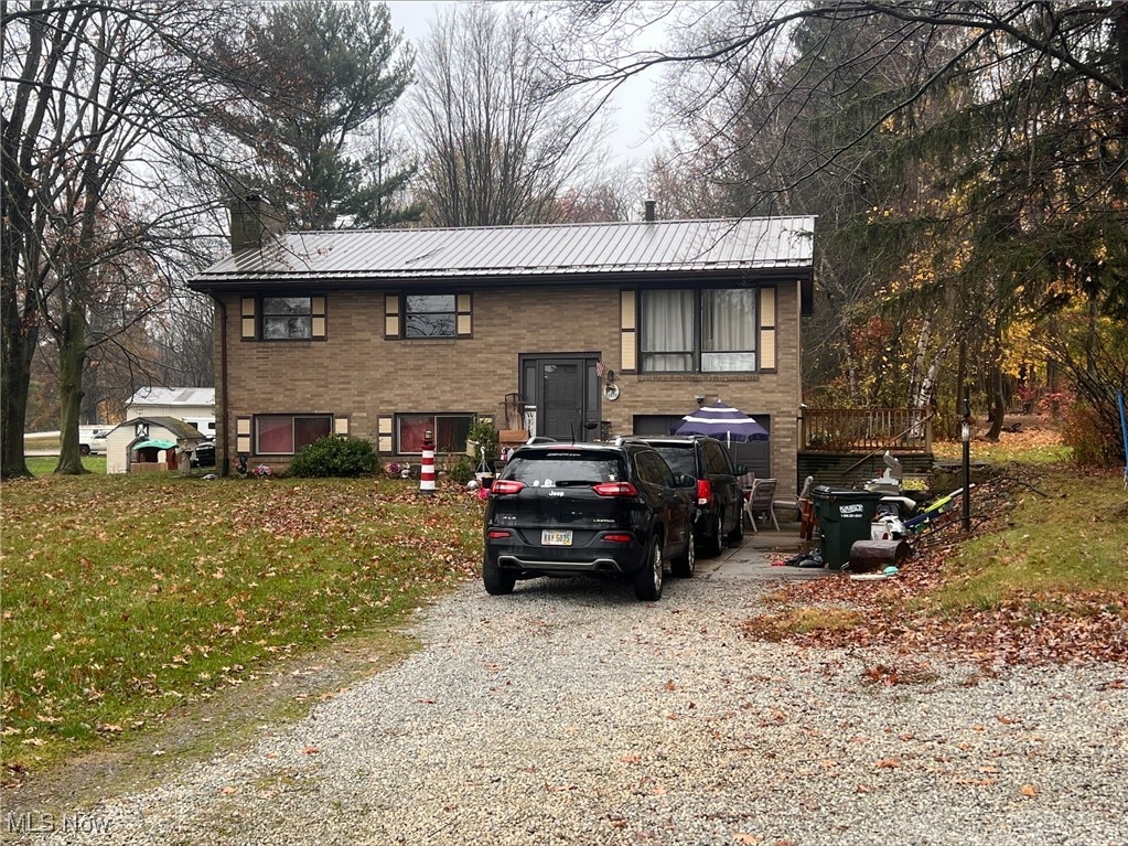 13270 Doylestown Rd, Rittman, OH 44270 - raised ranch with a chimney, driveway, and metal roof