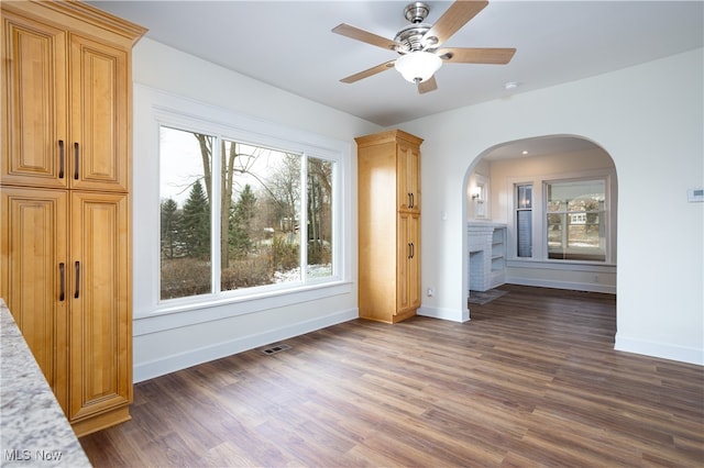 interior space featuring dark hardwood / wood-style flooring and ceiling fan