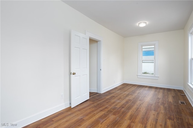 spare room with dark hardwood / wood-style floors