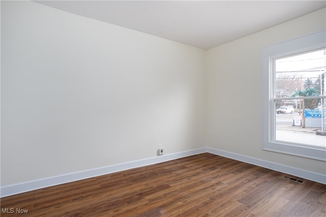 spare room with dark hardwood / wood-style floors