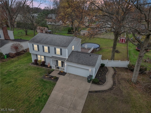 view of front of home with a yard and a garage