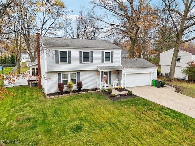 view of front of property with a front yard and a garage