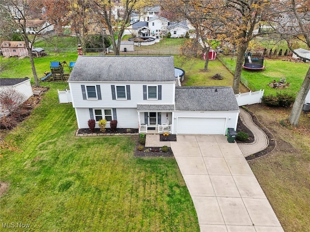 view of front of home with a garage, a front yard, and a porch