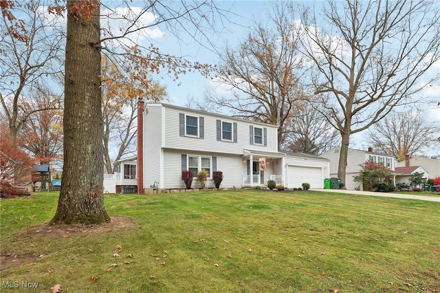 view of front of property with a garage and a front yard