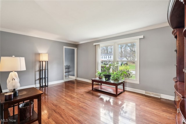 living room with hardwood / wood-style floors and ornamental molding