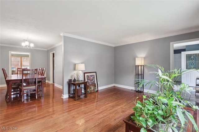 living room featuring hardwood / wood-style floors, a notable chandelier, and ornamental molding