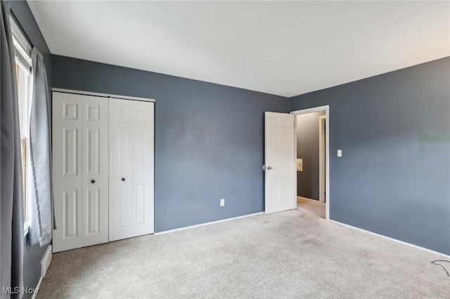 unfurnished bedroom with carpet and a closet