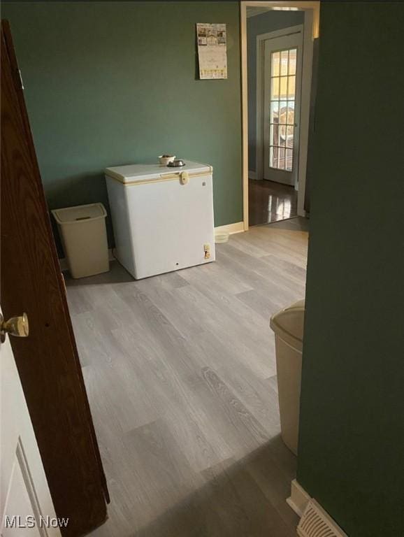 bathroom with hardwood / wood-style floors