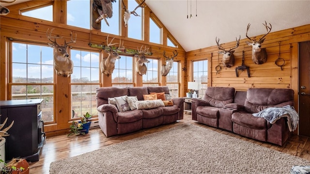 living room featuring hardwood / wood-style flooring, plenty of natural light, and wood walls