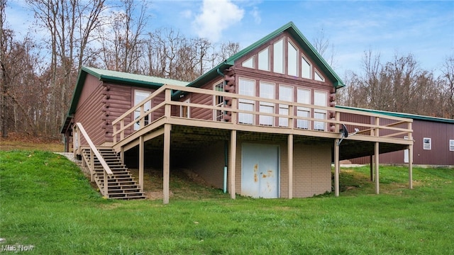 back of property with a lawn and a deck