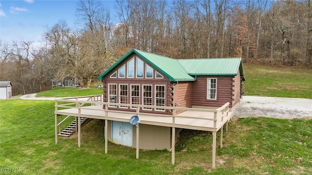 back of house with a lawn and a wooden deck